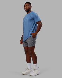 Man wearing Washed Daily 5" Shorts - Circular Grey