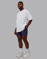 Man wearing Washed Daily 5" Shorts - Midnight Blue