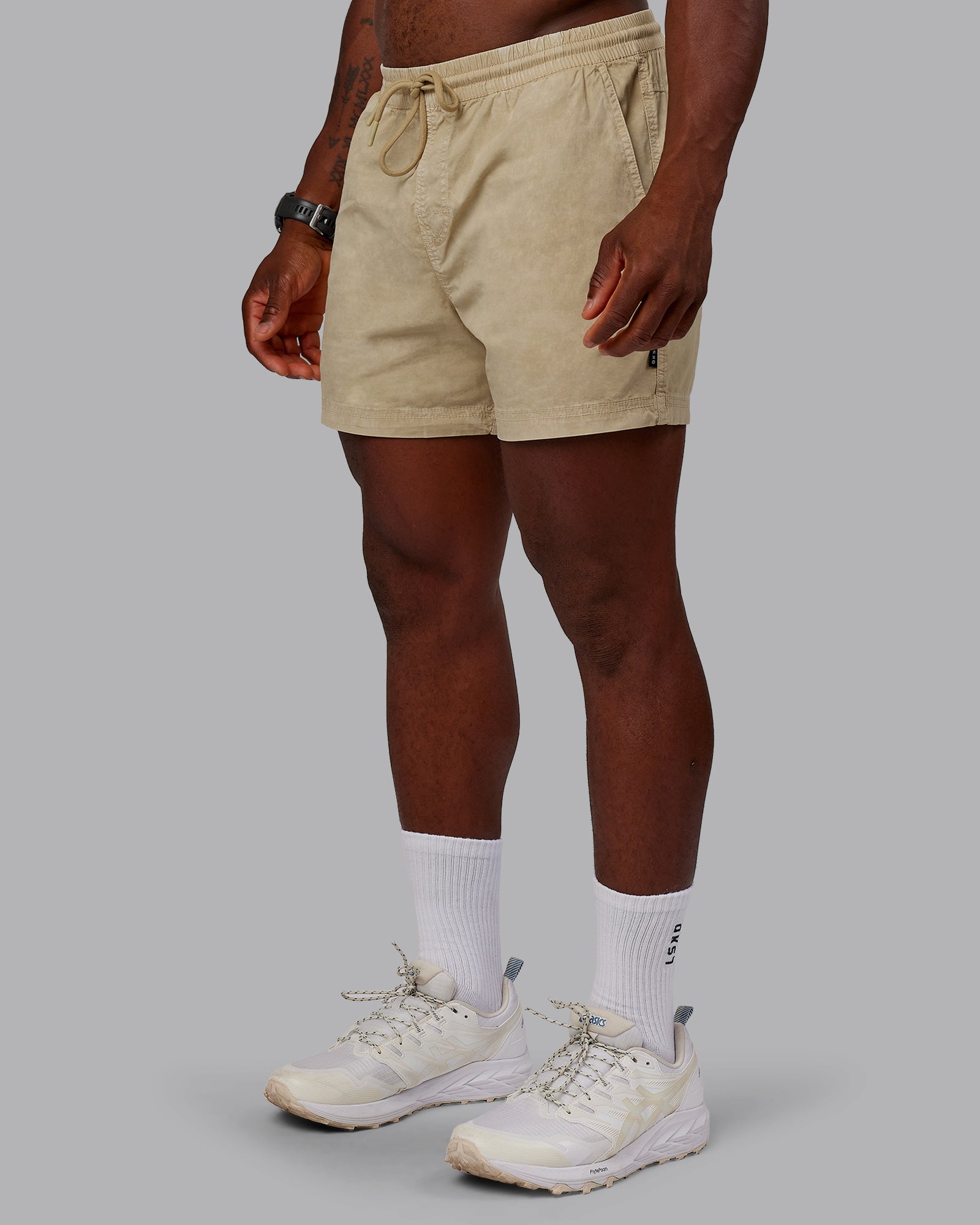 Man wearing Washed Daily 5" Shorts - Pale Khaki