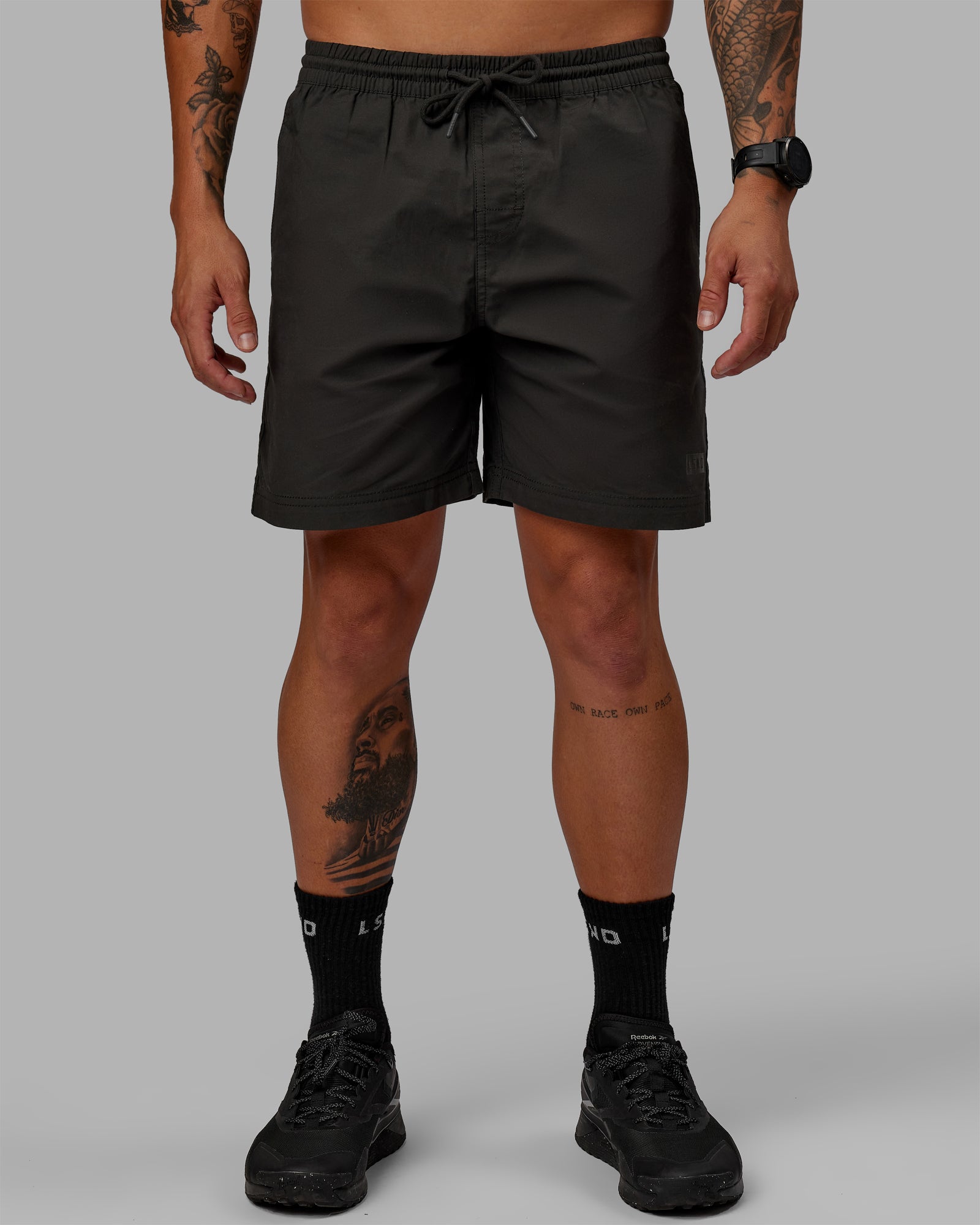 Man wearing 7" Daily Shorts - Pirate Black | Model:Jemile | Size:M