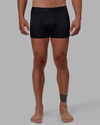 Man wearing daily trunks - black.
