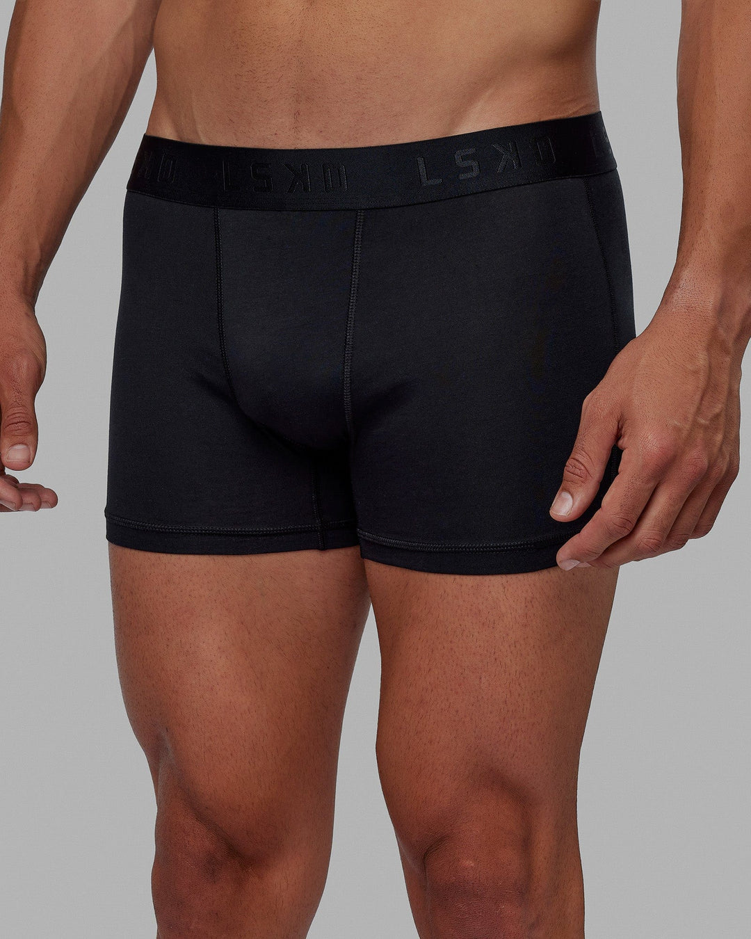 Man wearing daily trunks - black.