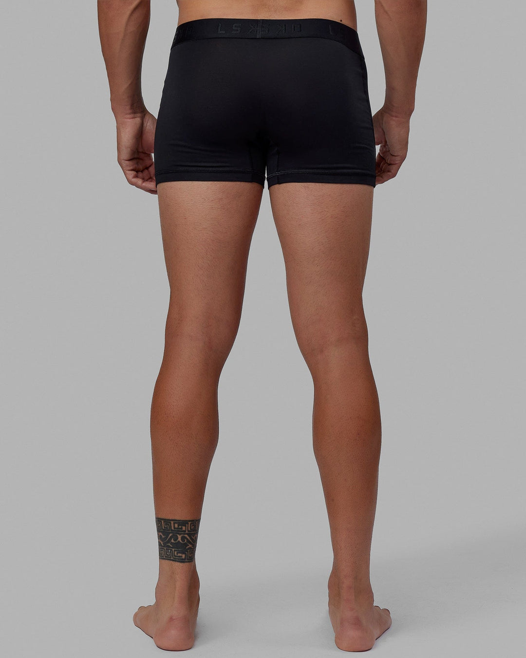 Man wearing daily trunks - black.