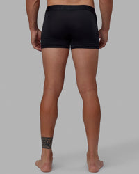Man wearing daily trunks - black.