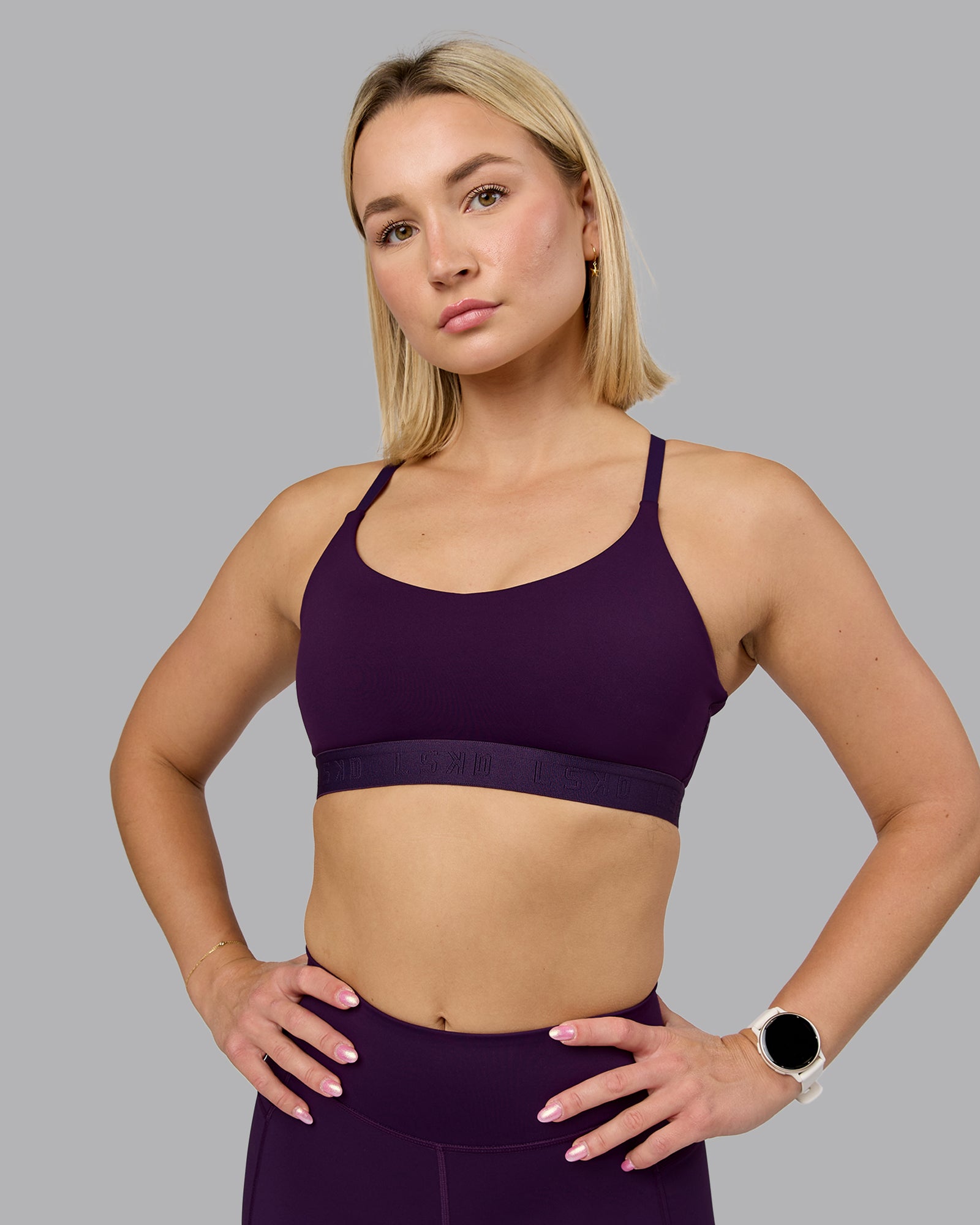 Woman wearing Define Sports Bra - Deep Purple | Model:Halle | Size:S