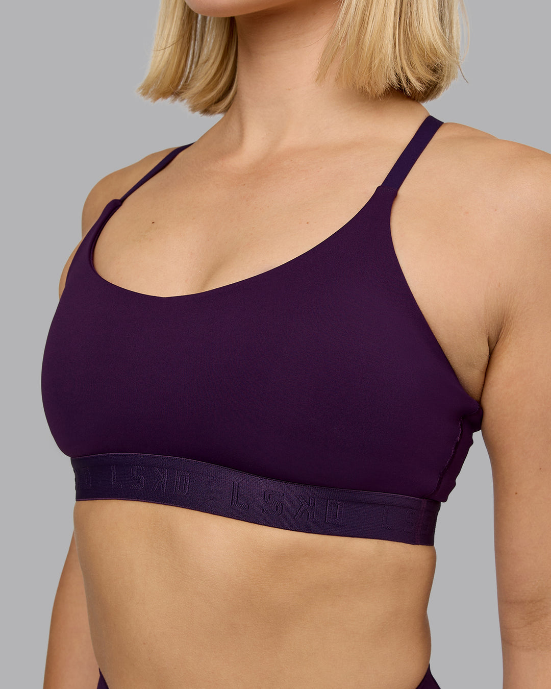 Woman wearing Define Sports Bra - Deep Purple | Model:Halle | Size:S