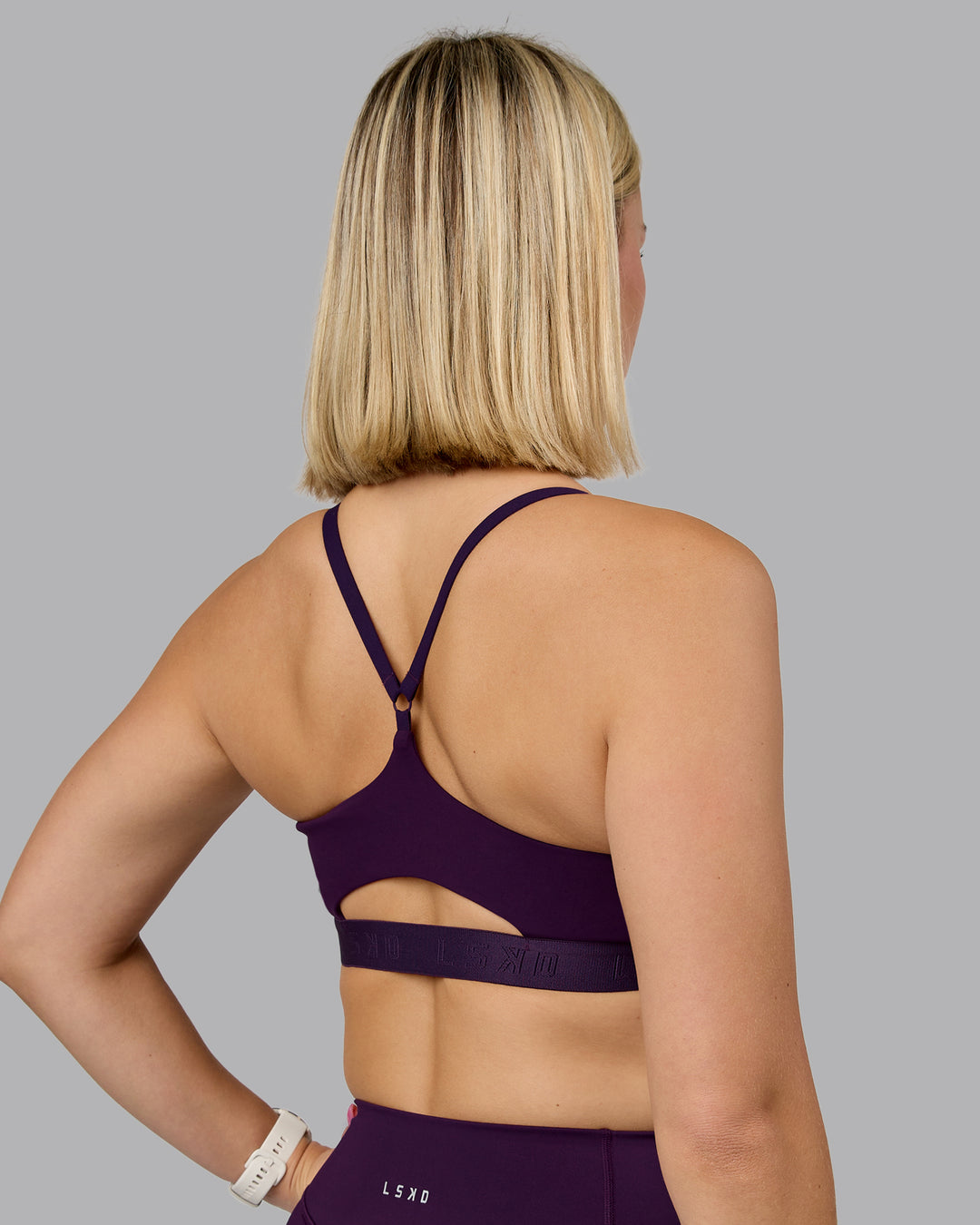 Woman wearing Define Sports Bra - Deep Purple | Model:Halle | Size:S