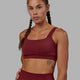 Woman wearing Elevation Sports Bra - Cranberry