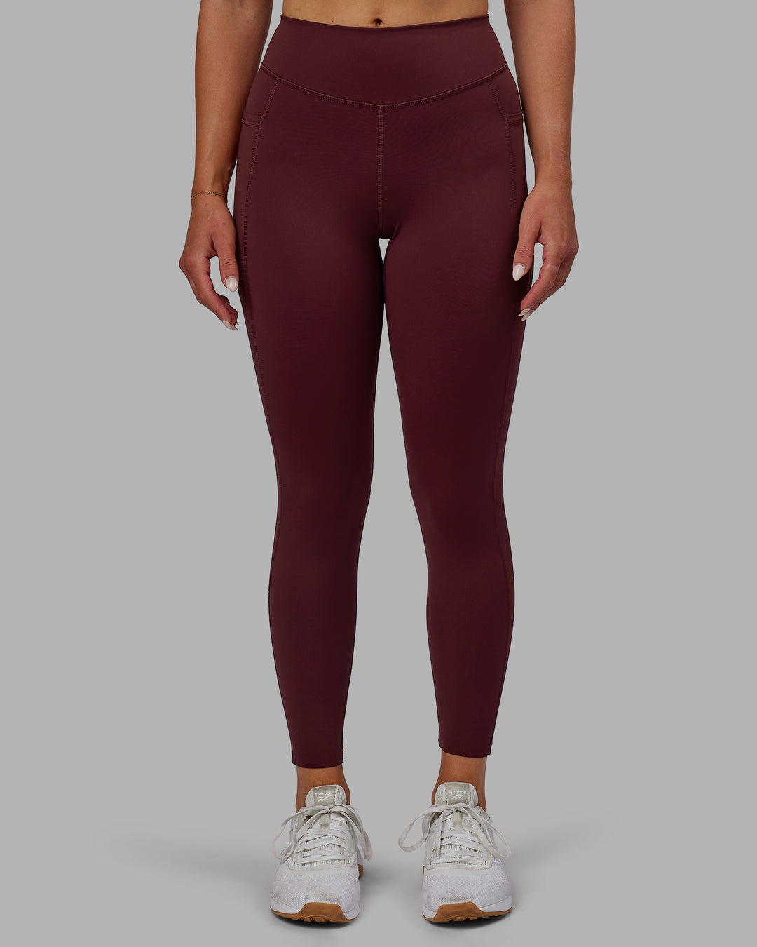 Woman wearing Elite High-Rise 7/8 Legging Pockets - Dark Cherry