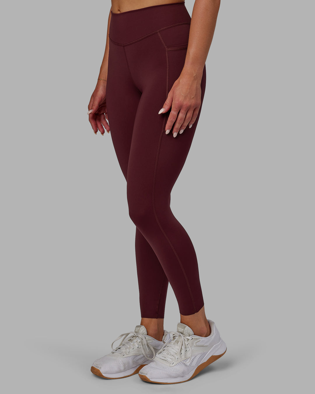 Woman wearing Elite High-Rise 7/8 Legging Pockets - Dark Cherry