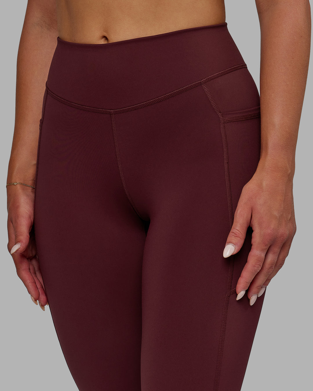 Woman wearing Elite High-Rise 7/8 Legging Pockets - Dark Cherry