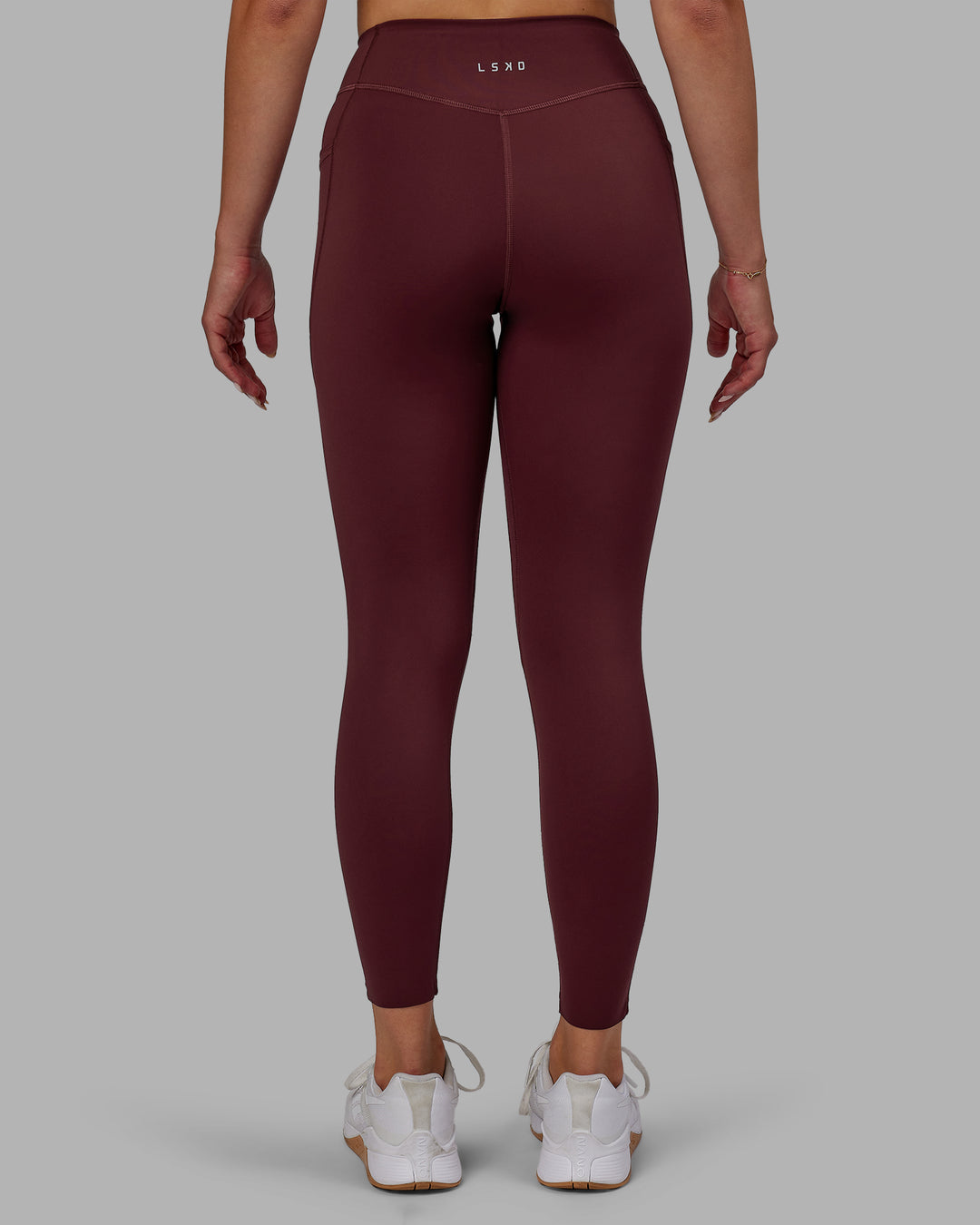 Woman wearing Elite High-Rise 7/8 Legging Pockets - Dark Cherry