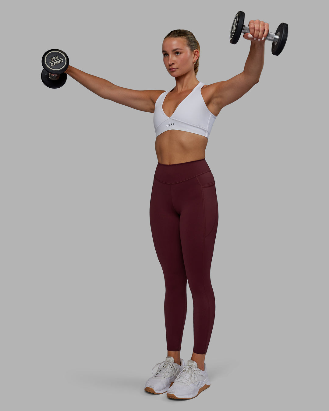 Woman wearing Elite High-Rise 7/8 Legging Pockets - Dark Cherry