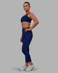 Woman wearing Elite High-Rise 7/8 Legging Pockets - Midnight Blue