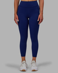 Woman wearing Elite High-Rise 7/8 Legging Pockets - Midnight Blue