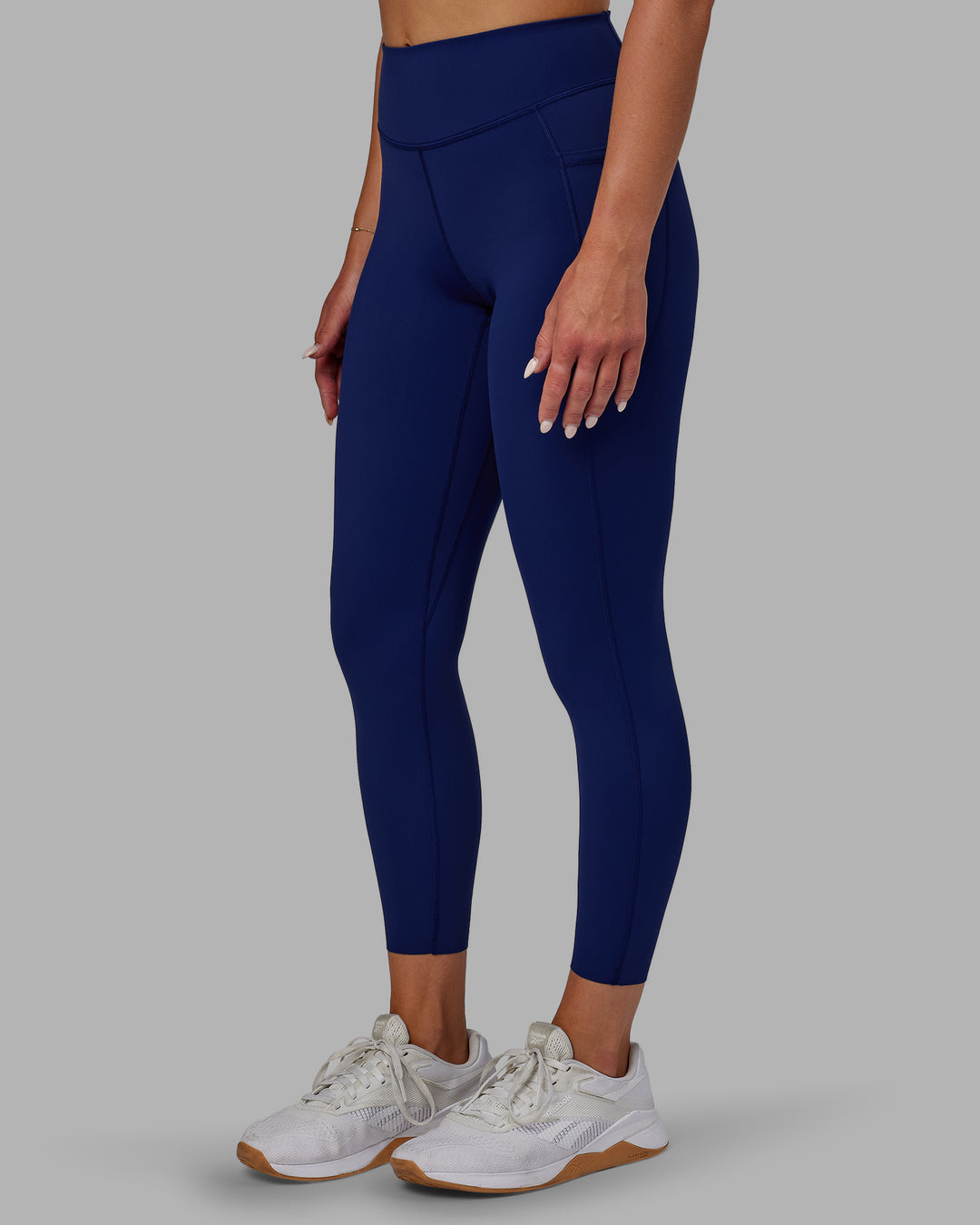 Woman wearing Elite High-Rise 7/8 Legging Pockets - Midnight Blue