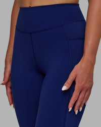 Woman wearing Elite High-Rise 7/8 Legging Pockets - Midnight Blue