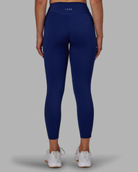 Woman wearing Elite High-Rise 7/8 Legging Pockets - Midnight Blue