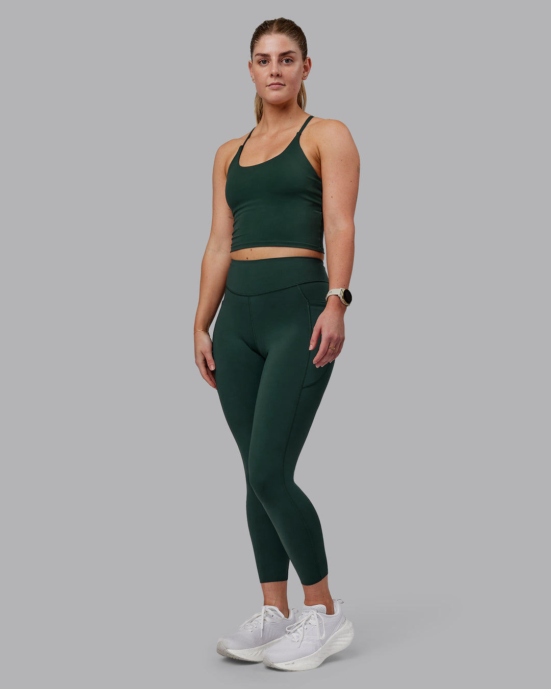 Woman wearing Elite High-Rise 7/8 Legging Pockets - Vital Green