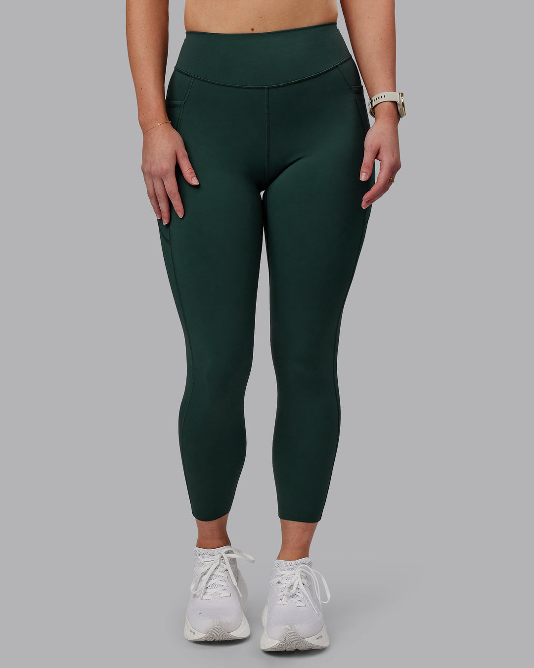 Woman wearing Elite High-Rise 7/8 Legging Pockets - Vital Green