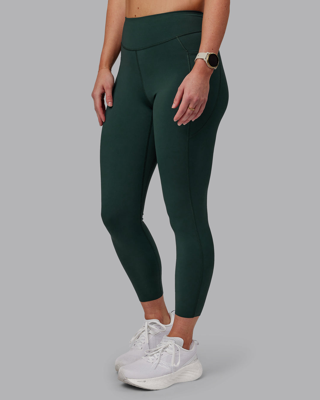 Woman wearing Elite High-Rise 7/8 Legging Pockets - Vital Green