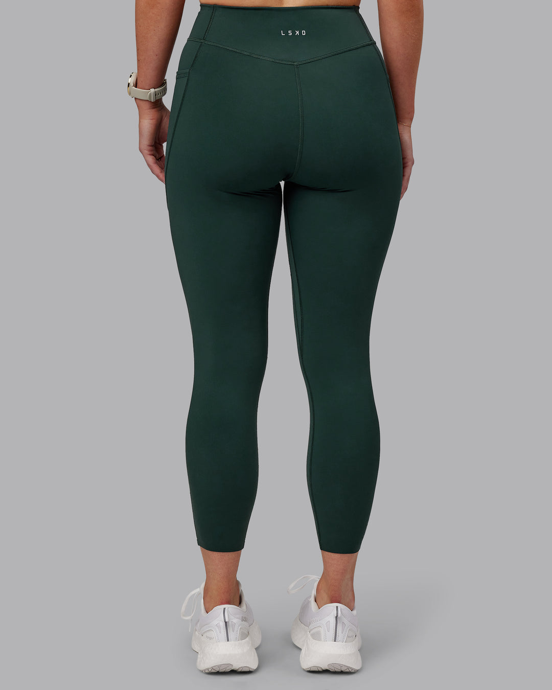 Woman wearing Elite High-Rise 7/8 Legging Pockets - Vital Green