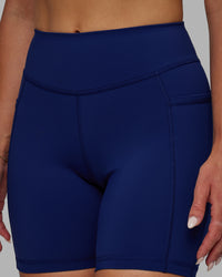 Woman wearing Elite High-Rise 6" Short Pockets - Midnight Blue