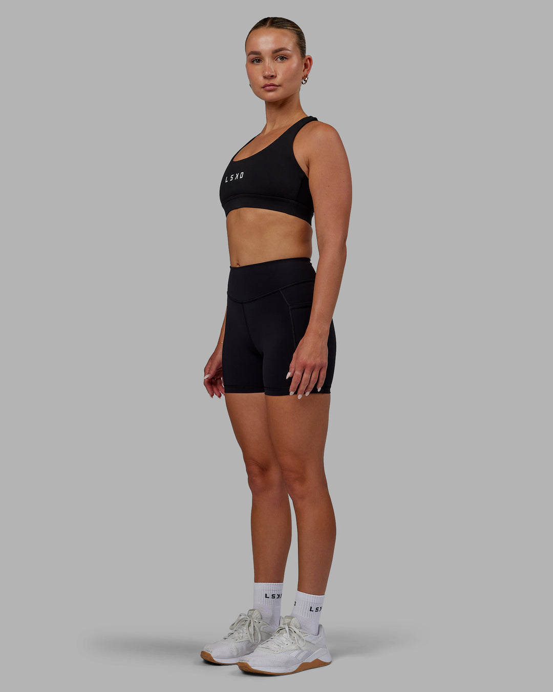 Woman wearing Elite High-Rise 4&quot; Short Pockets - Black