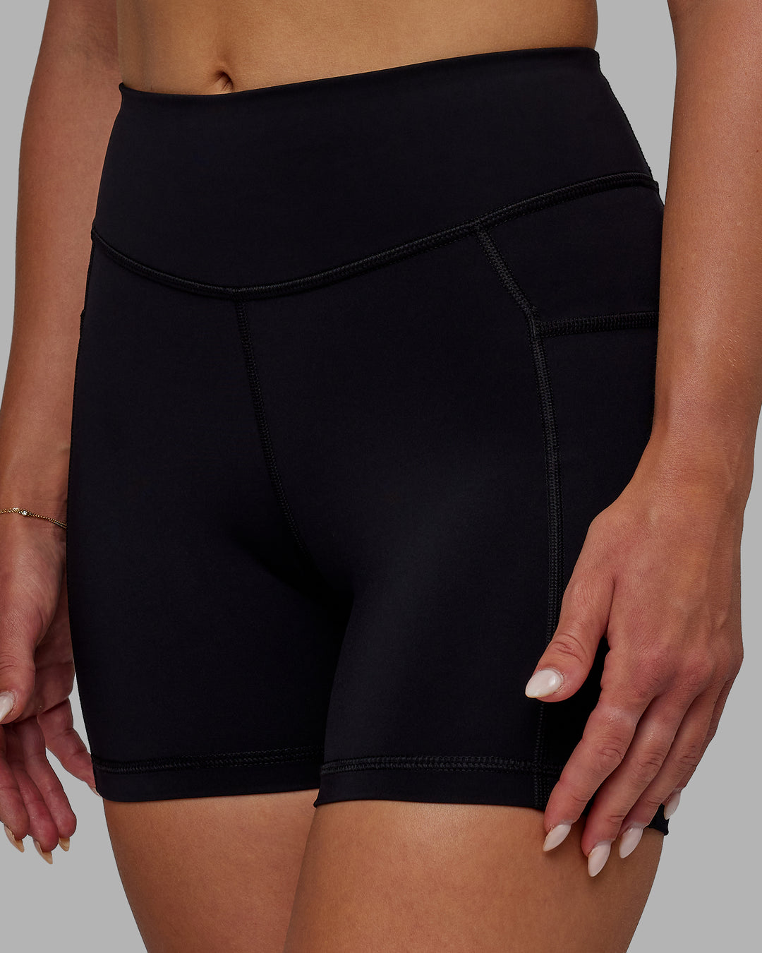 Woman wearing Elite High-Rise 4&quot; Short Pockets - Black