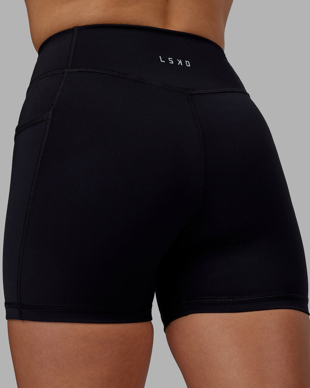 Woman wearing Elite High-Rise 4&quot; Short Pockets - Black