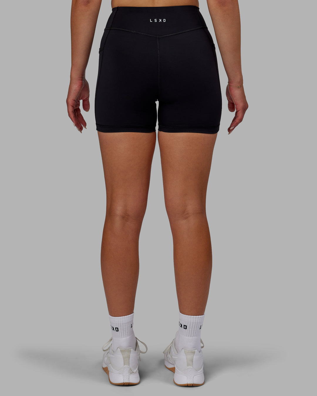 Woman wearing Elite High-Rise 4&quot; Short Pockets - Black