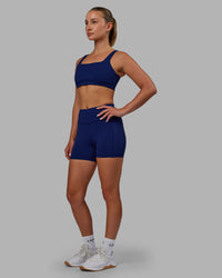Woman wearing Elite High-Rise 4" Short Pockets - Midnight Blue