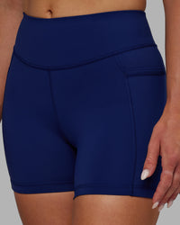 Woman wearing Elite High-Rise 4" Short Pockets - Midnight Blue