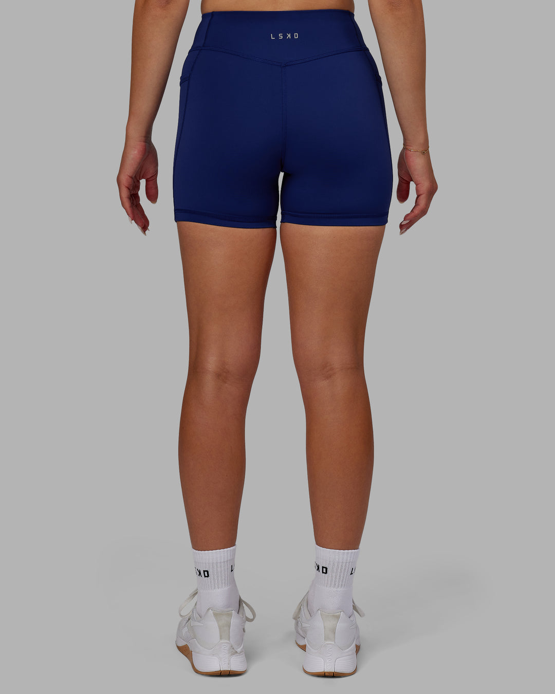 Woman wearing Elite High-Rise 4" Short Pockets - Midnight Blue