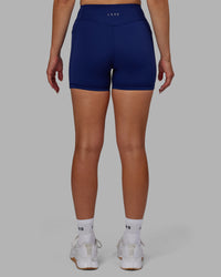 Woman wearing Elite High-Rise 4" Short Pockets - Midnight Blue