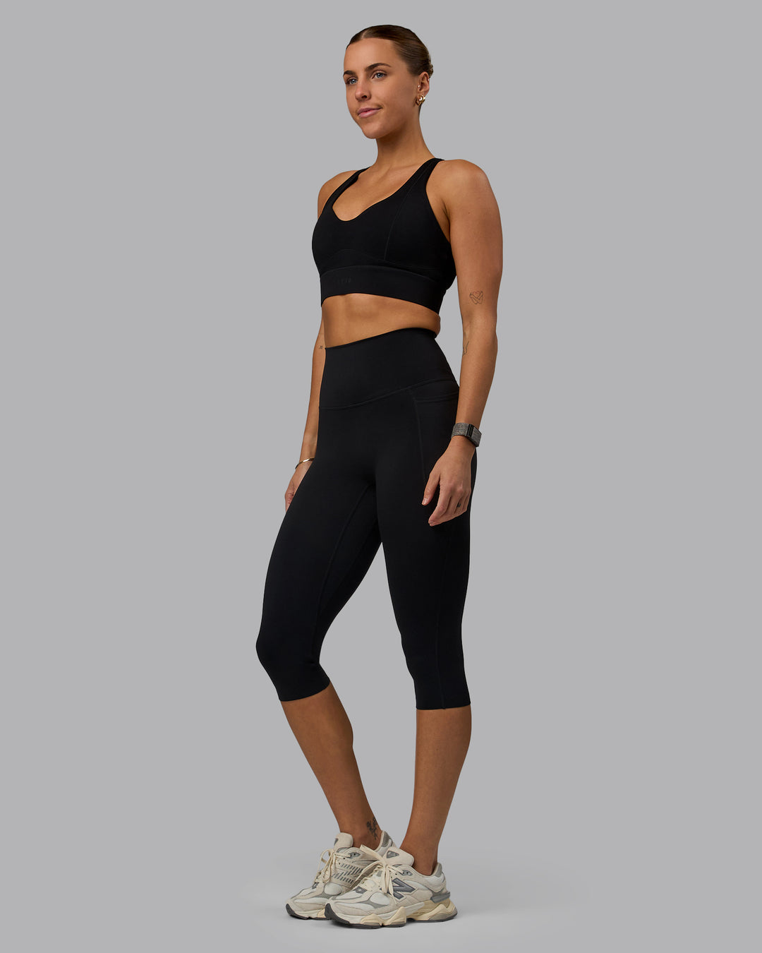 Woman wearing Elixir Ultra High-Rise 3/4 Legging Pockets - Black | Model:Shae | Size:S