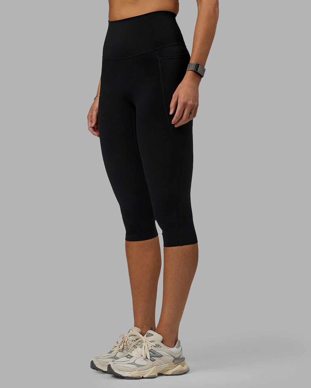 Woman wearing Elixir Ultra High-Rise 3/4 Legging Pockets - Black | Model:Shae | Size:S