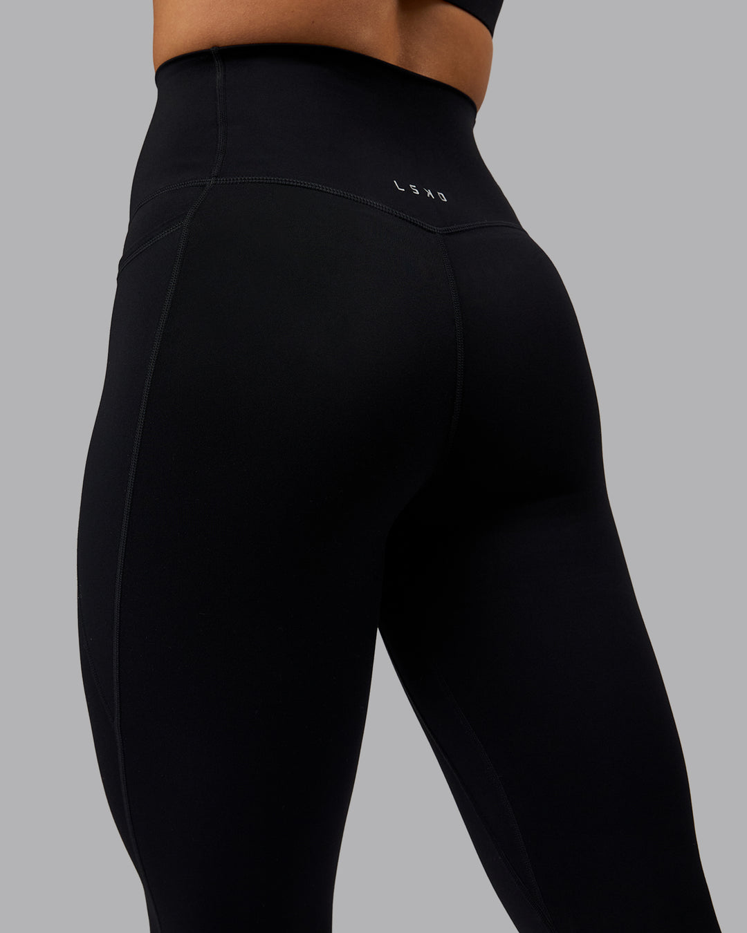Woman wearing Elixir Ultra High-Rise 3/4 Legging Pockets - Black | Model:Shae | Size:S