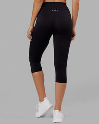 Woman wearing Elixir Ultra High-Rise 3/4 Legging - Black | Model:Chelsea | Size:S