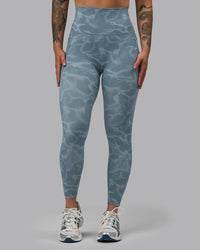 Woman wearing Elixir Ultra High-Rise 7/8 Legging Pockets - Tranquil-Elemental Blue | Model:Robyn | Size:S