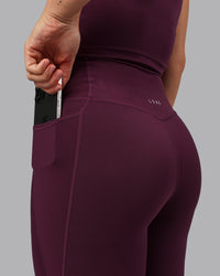 Woman wearing Elixir Ultra High-Rise 7/8 Legging Pockets - Cherry Lacquer | Model:Lyss | Size:S