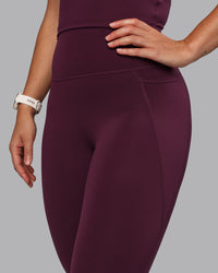 Woman wearing Elixir Ultra High-Rise 7/8 Legging Pockets - Cherry Lacquer | Model:Lyss | Size:S