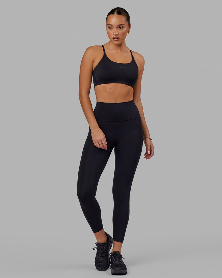 Woman wearing Elixir 7/8 Tights With Pockets - Black