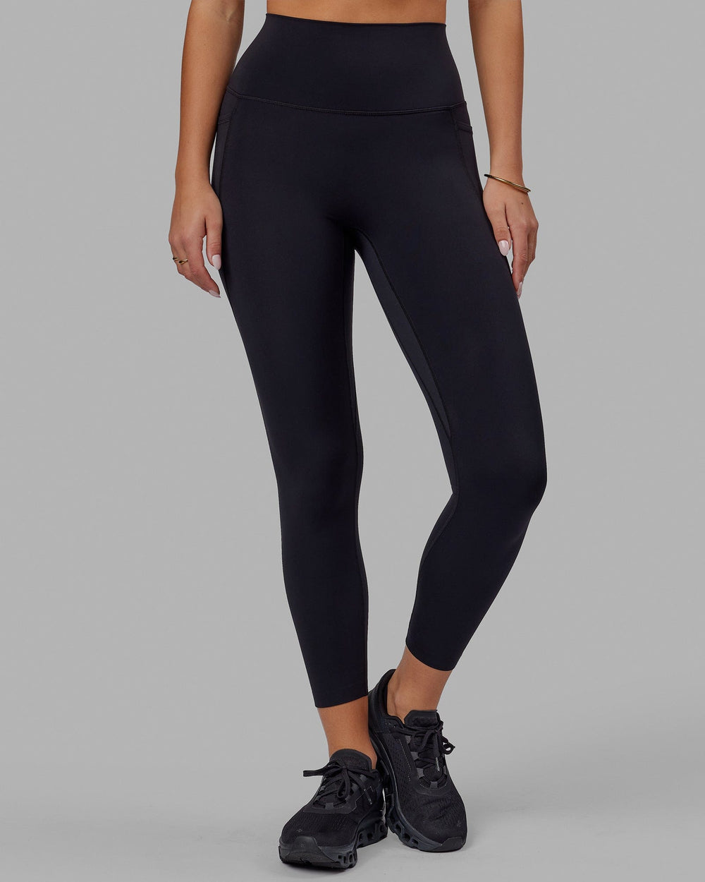 Woman wearing Elixir 7/8 Tights With Pockets - Black