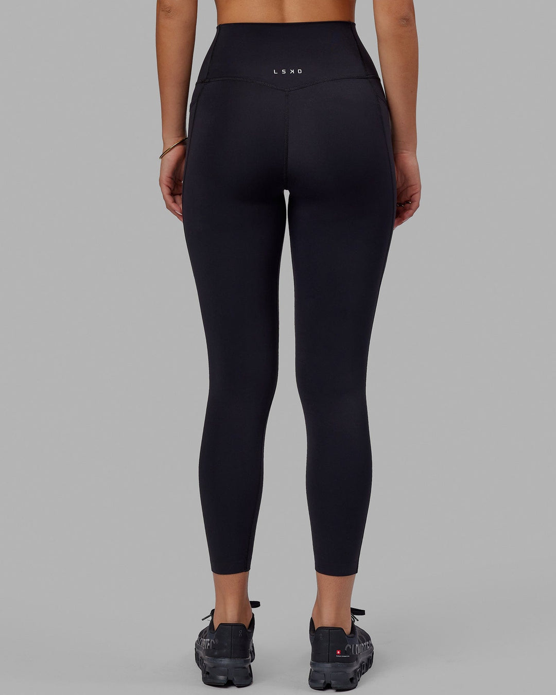 Woman wearing Elixir 7/8 Tights With Pockets - Black