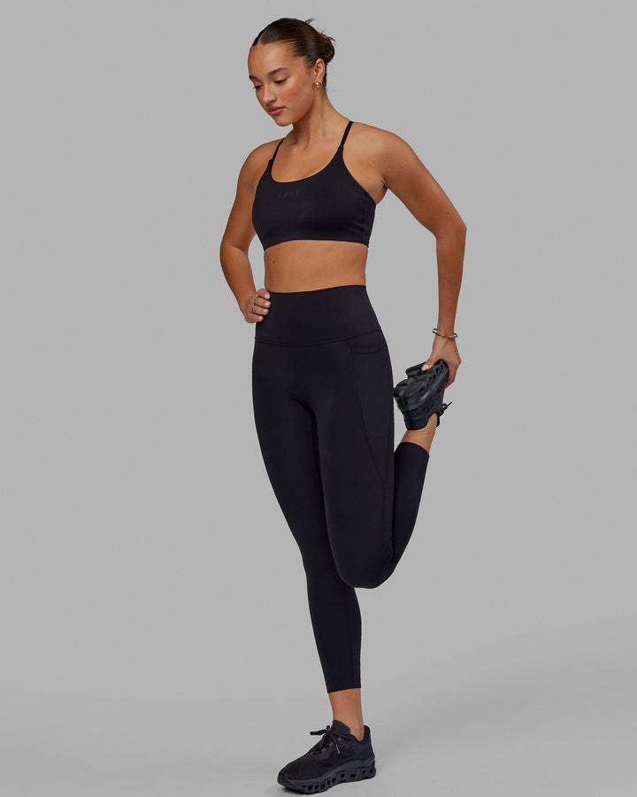 Woman wearing Elixir 7/8 Tights With Pockets - Black