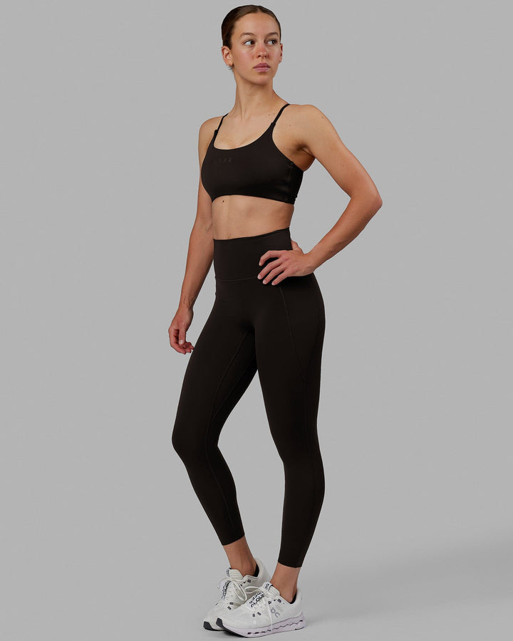 Woman wearing Elixir 7/8 Length Tights With Pockets - Dark Walnut