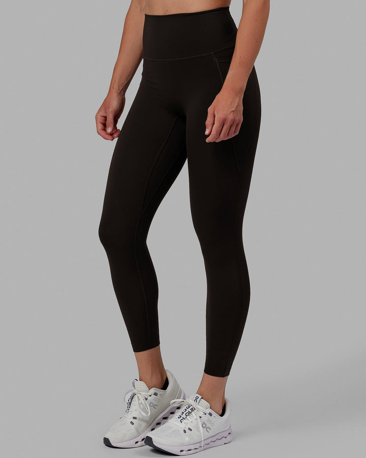 Woman wearing Elixir 7/8 Length Tights With Pockets - Dark Walnut