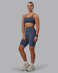 Woman wearing Elixir Ultra High-Rise 9" Short Pockets - Turbulence | Model:Suz | Size:S