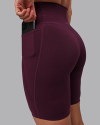 Woman wearing Elixir Ultra High-Rise 9" Short Pockets - Cherry Lacquer | Model:Lyss | Size:S